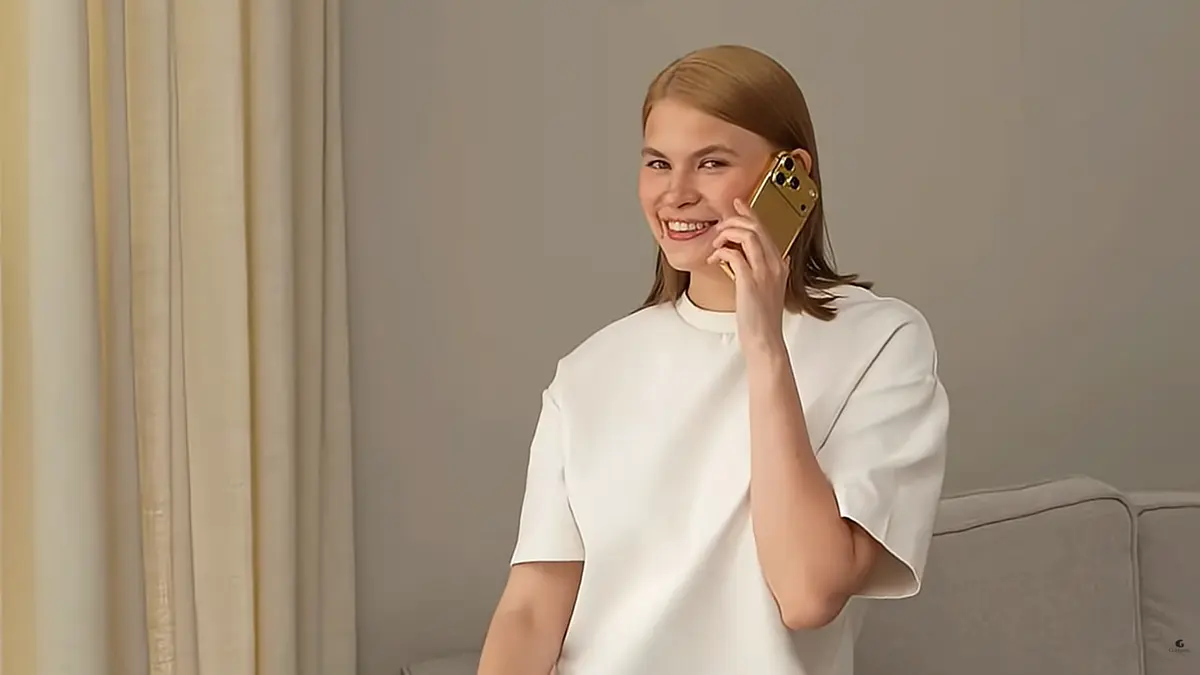 Handcrafted Goldgenie Gold iPhone beside Bitcoin and XRP cryptocurrency symbols.
